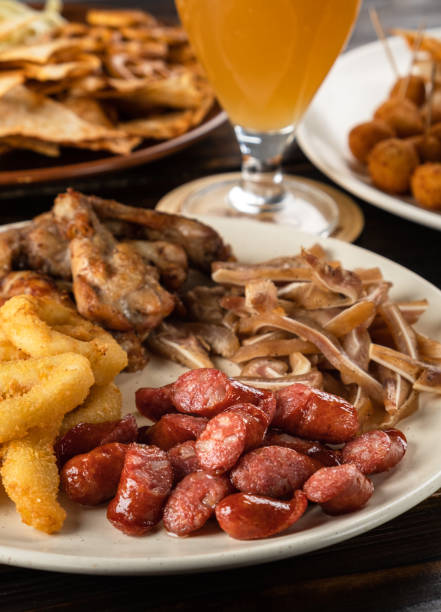 istock Beer appetizer assorted in a plate on a wooden table 1348967385