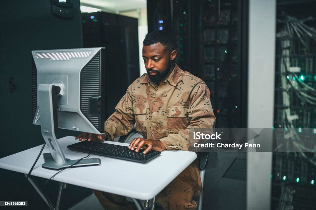 Shot of an male IT technician  in a server room and using a laptop Computer consultant at your call Technology Stock Photo