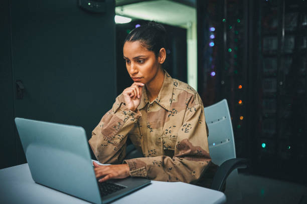 istock Shot of an female IT technician  in a server room and using a laptop 1348968264
