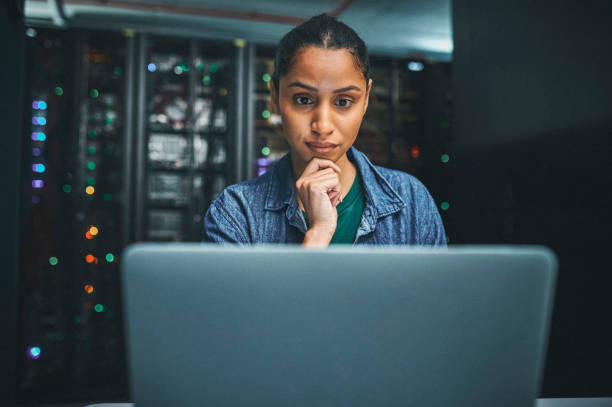 istock Shot of an female IT technician in a server room and using a laptop 1348968278