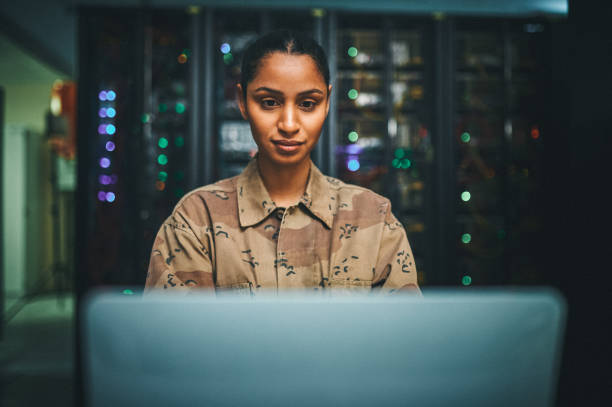 istock Shot of an female IT technician  in a server room and using a laptop 1348968289