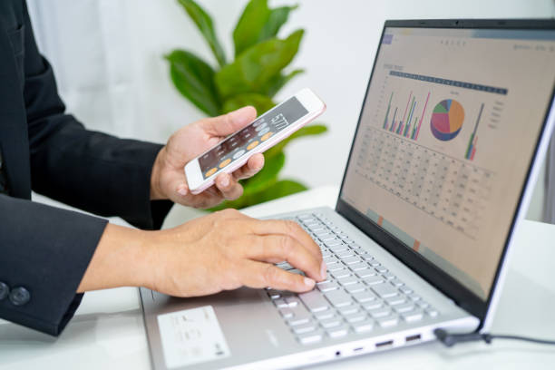 istock Asian accountant working and analyzing financial reports project accounting with chart graph and calculator in modern office, finance and business concept. 1348968330