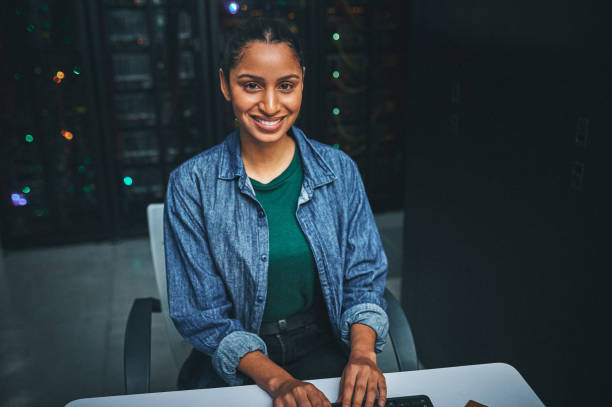 istock Shot of an female IT technician  in a server room and using a laptop 1348968728