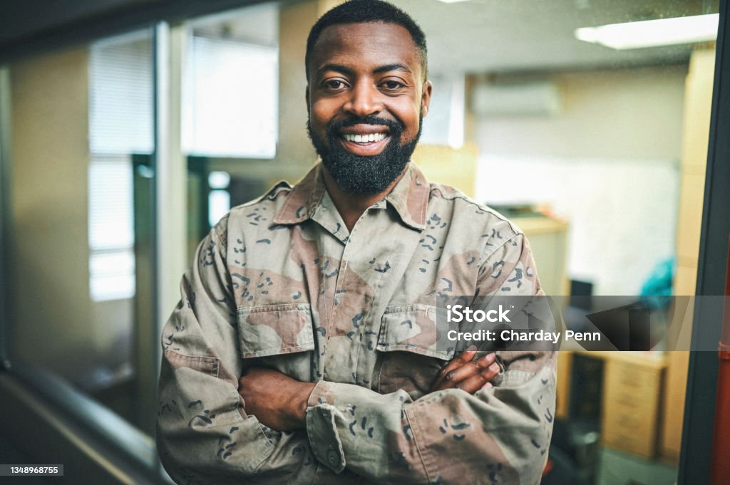 Shot of a male soldier standing in a office room Confidence breeds success Army Stock Photo