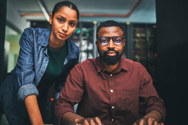 istock Shot of a two IT technicians working in a server room 1348968771