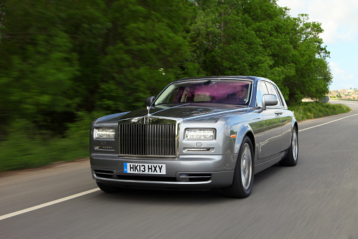 Paris, France - April 18th 2015 : Half-face Black Rolls Royce Phantom parked in a street, in George V quarter.