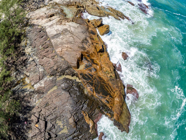 istock Aerial view with waves, rocks and pine trees 1348970060
