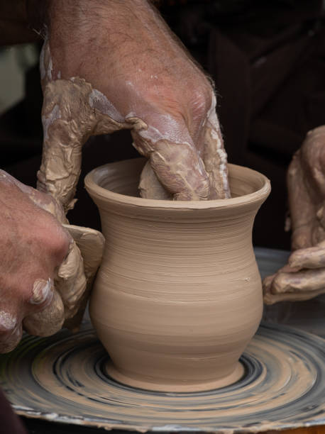 istock Master class on modeling of clay on a potter's wheel In the pottery workshop 1348971822