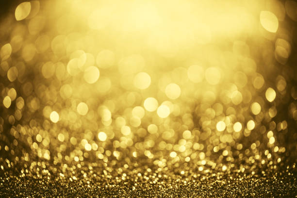 istock Golden glitter bokeh lighting texture Blurred abstract background for birthday, anniversary, wedding, new year eve or Christmas 1348973511