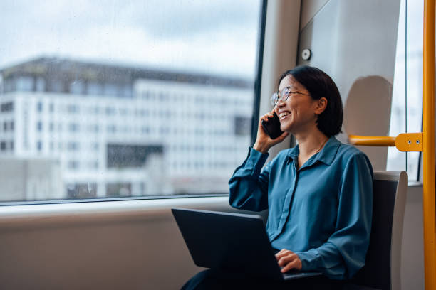 istock Asian woman having a phone call while traveling. 1348973917