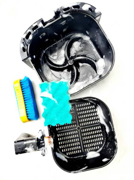istock Cleaning air fryer using sponge. 1348974007
