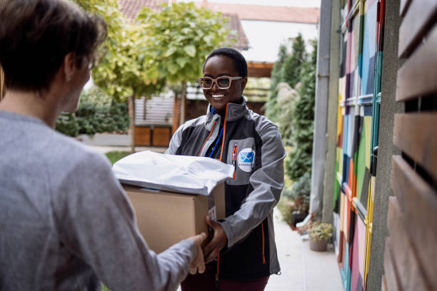 istock Homeowner receives parcel while standing in the open doorway. 1348975597