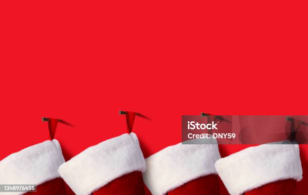 Row Of Christmas Stockings On Red Stocking Stock Photo - Download Image Now - Christmas Stocking, Backgrounds, Holiday - Event