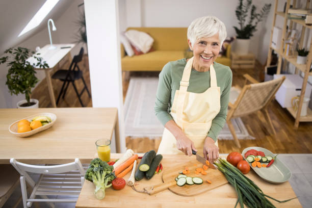 istock Old woman preparing organic food 1348976815