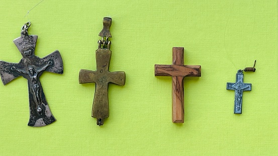 Small crosses, crucifixes on green background