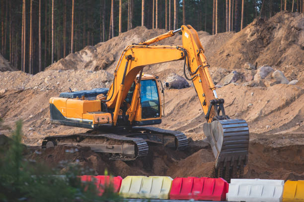 istock Yellow heavy excavator and bulldozer excavating sand and working during road works, unloading sand during construction of the new road 1348979421