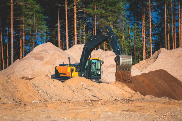 istock Yellow heavy excavator and bulldozer excavating sand and working during road works, unloading sand during construction of the new road 1348979426