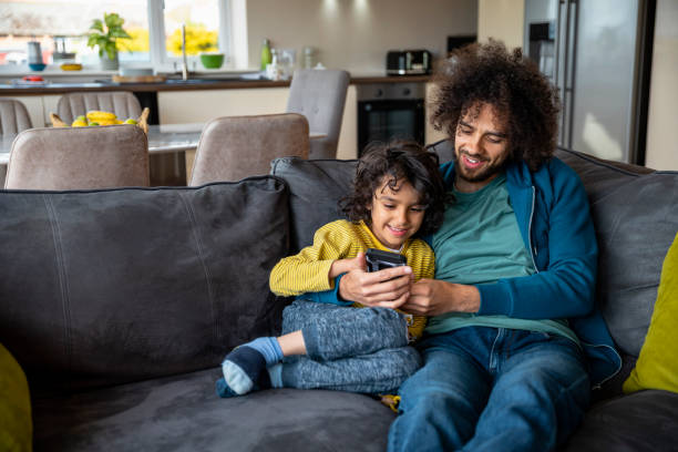 istock Father and Son Relaxing on the Sofa 1348979588