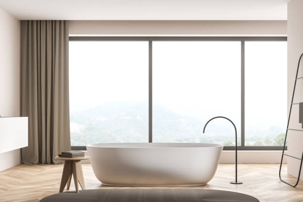 istock Oval bathtub in modern panoramic beige bathroom 1348979820