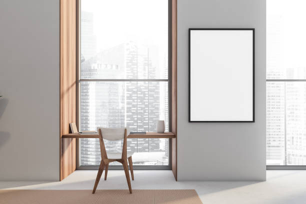 istock Empty framed canvas on hotel room wall with desk in niche window 1348981851