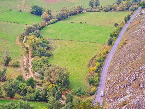 istock mountain road surrounded by greenery photographed from above 1348985052