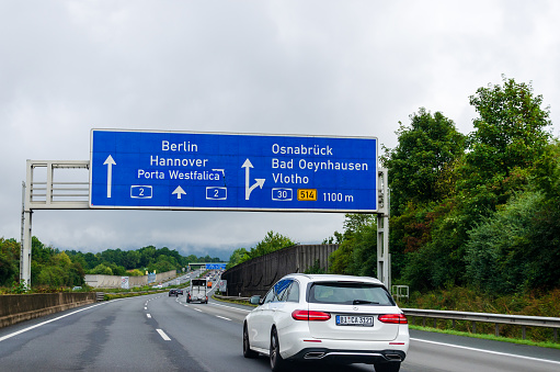 North Rhine-Westphalia, Germany - August 28, 2021: Road traffic on the German Highway (Autobahn, Bundesautobahn) A2 with road signs.