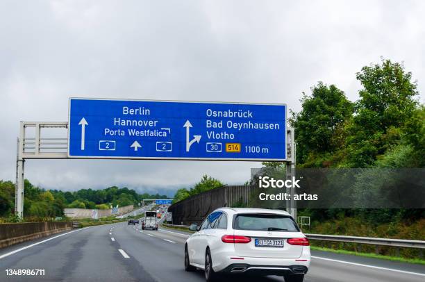 Road Traffic On The German Highway A2 With Road Signs Stock Photo - Download Image Now