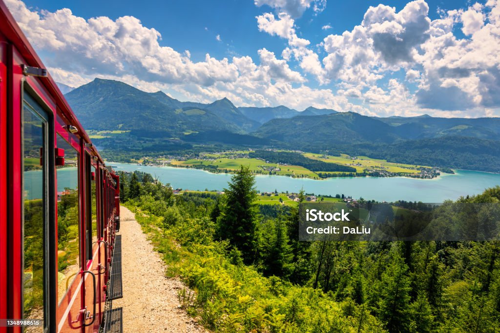 Schafbergbahn mountain train, Schafberg mountain, Salzkammergut region, Salzburg Land state, Austria. Journey to the top of Alps through lush fields and green forests.View of lake Wolfgangsee. Austria Stock Photo