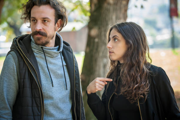 istock Young couple in quarrel conflict, pointing each other with finger 1348989953