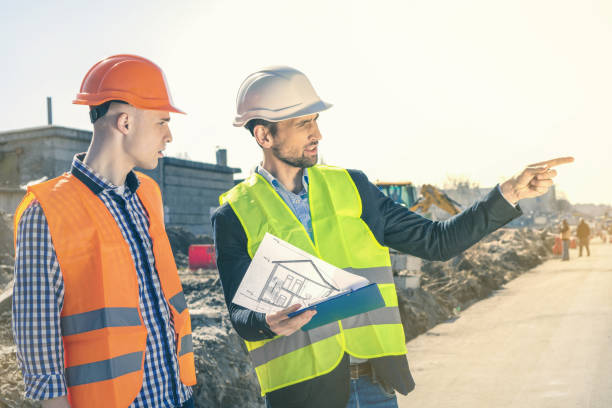 istock Group of construction engineers on a building plot. Real Estate Project with Civil Engineer. 1348992623