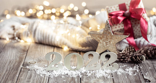 istock Cozy festive composition with the numbers 2022 and decor details close up. 1348992696