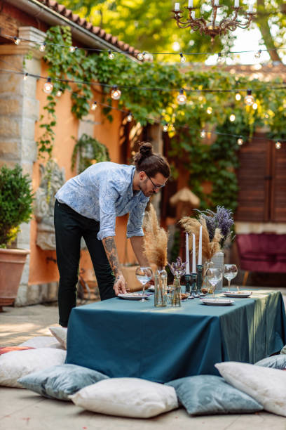 istock He is preparing table for diner with friends 1348995511