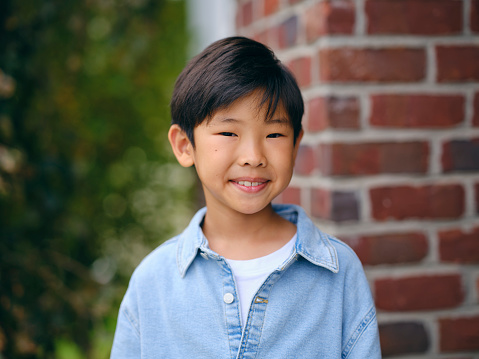 A natural light portrait of a Korean ethnicity boy.