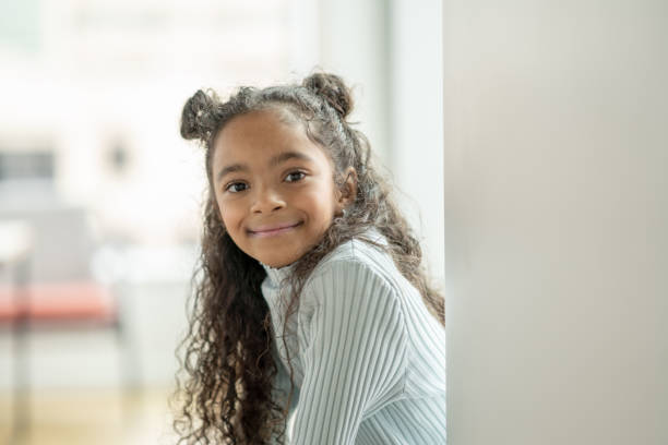 istock Young Girl on a Window Ledge Portrait 1348999247