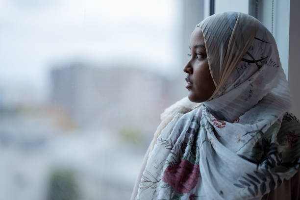 istock Muslim Woman Looking Out the Window 1348999263