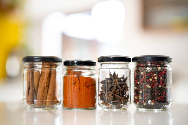 Exotic spices in reused glass jars on kitchen counter