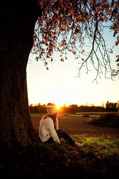 istock Young woman watching the autumn sunset 1349008013