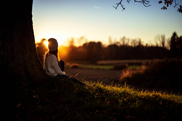istock Young woman watching the autumn sunset 1349008244