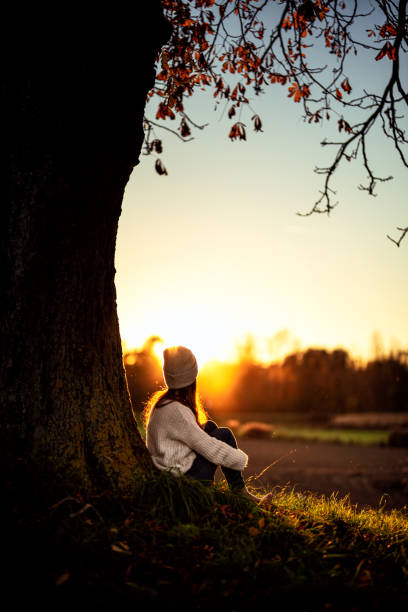 istock Young woman watching the autumn sunset 1349008295
