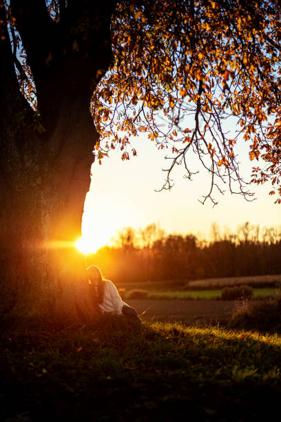 istock Young woman watching the autumn sunset 1349008509