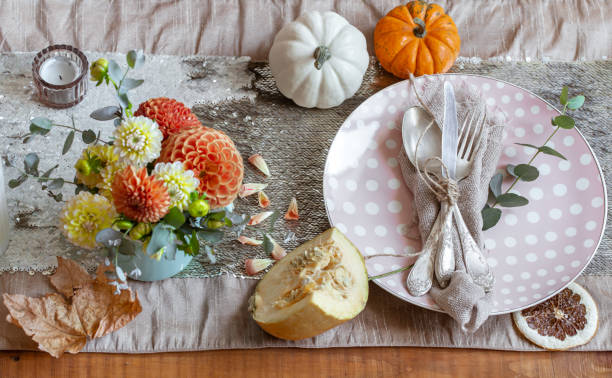 istock Festive table setting with pumpkins, candles and chrysanthemum flowers. 1349008628