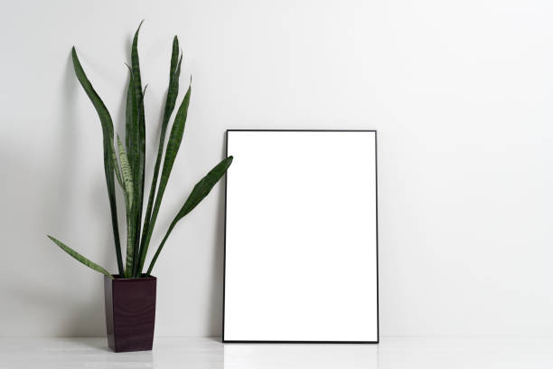 istock Blank canvas frame mockup on white wall. View of modern scandinavian style interior with artwork mock up on wall 1349008753