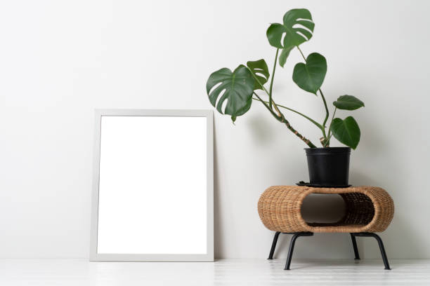 istock Blank canvas frame mockup on white wall. View of modern scandinavian style interior with artwork mock up on wall 1349008795