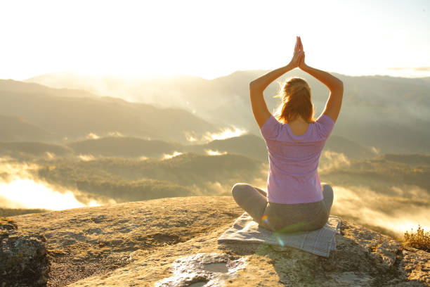 istock Woman doing yoga pose in the mountain 1349009959