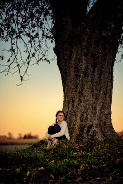 istock Young girl watching the autumn sunset 1349010149