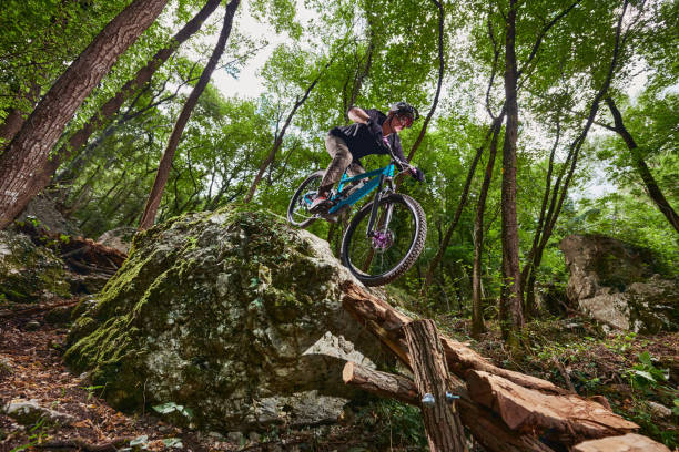 Enduro biker on a self-constructed challenging trail in the woods
