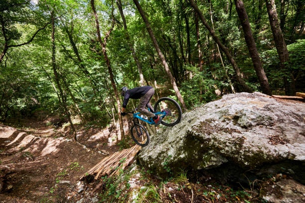 istock Enduro biker on a self-constructed challenging trail in the woods 1349010186