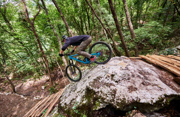 istock Challenging drop for an enduro biker on a self-constructed trail in the woods 1349010188