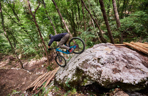 istock Challenging drop for an enduro biker on a self-constructed trail in the woods 1349010198