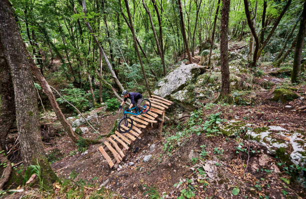 istock Enduro biker descending over challenging drop on a self-constructed trail in the woods 1349010223